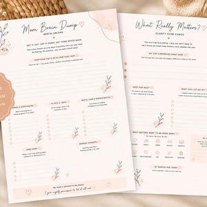 May include: Two-page planner with the text "Mom Brain Dump" and "What Really Matters?" in a soft pink and beige color scheme. The planner includes sections for tasks, thoughts, and priorities, with floral accents and a circular sticker that says "Clear Your Mind, Reduce Overwhelm, Feel Like You Again."