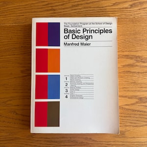 May include: A book titled "Basic Principles of Design" by Manfred Maier. The cover features a white background with a vertical color block design in red, orange, blue, and brown. Text includes "The Foundation Program at the School of Design Basel, Switzerland."