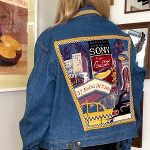 Vintage 80’s 90’s Kolorway Blue Denim Jean Jacket • Needlepoint New York City Patchwork on Back • Checkered Yellow Braid Trim • Western • L