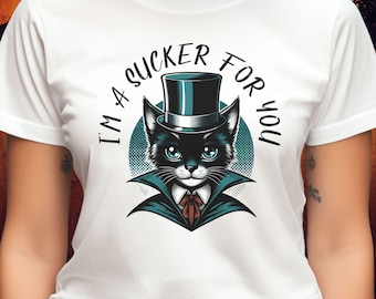 May include: White t-shirt with a black cat wearing a top hat and a blue cape. The text "I'm a sucker for you" is written around the cat.