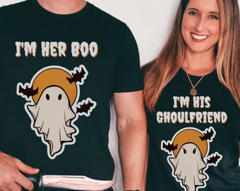 May include: Two black t-shirts with a ghost and moon graphic. The text on the shirts reads "I'm her boo" and "I'm his ghoulfriend".