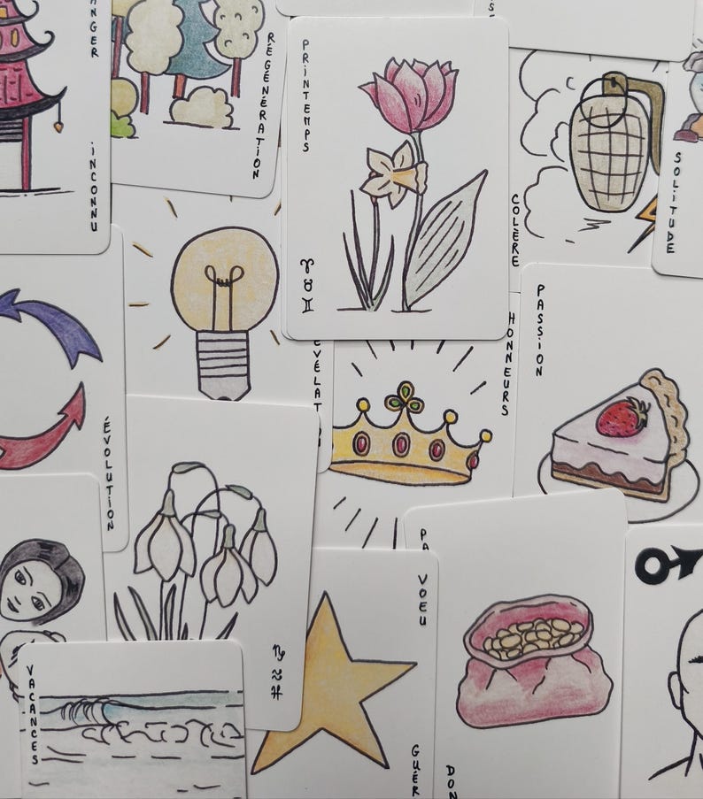 May include: A collection of illustrated cards with various drawings and text. The cards feature images of a lightbulb, a flower, a crown, and a slice of cake. Text includes words like "Spring", "Evolution", and "Passion".