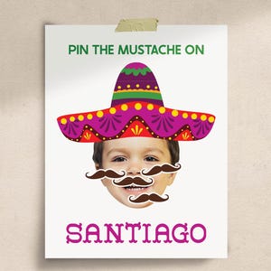 May include: A white poster featuring the text PIN THE MUSTACHE ON SANTIAGO in green and purple. The design includes a colorful sombrero in purple, red, yellow, and green, positioned above a child's face with three brown mustache cutouts.