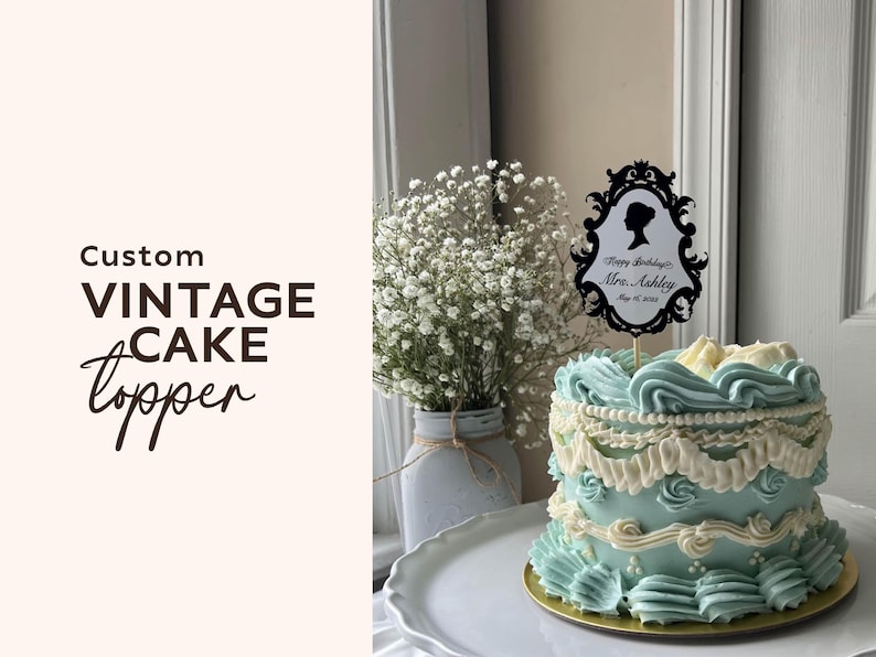 May include: A custom vintage cake topper with a black silhouette design and the text "Happy Birthday Mrs. Ashley May 15, 2023" sits atop a light blue cake with white frosting. The cake is on a white plate.