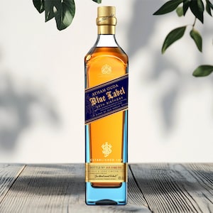May include: A bottle of Johnnie Walker Blue Label whiskey with a blue and gold label. The bottle has a gold cap and a blue base. The label reads "Ayham Ouda 50th Birthday". The bottle is on a wooden surface.