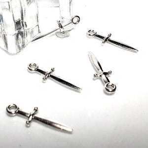BULK 100 Pc Lot Sword Charm, Dagger Charm, Knife Charm, Fencing Charms,   Pendants Zinc Alloy 23X7 mm   Ships from Ohio