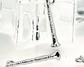 May include: Silver-colored clarinet charms. The charms are detailed with realistic instrument features, including keys and a bell. The charms have a loop at the top for attaching to jewelry or other crafts. The background is a light, neutral color.