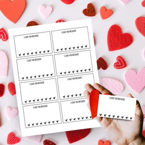 May include: Printable Valentine's Day cards with the text "I love you because" and a row of hearts at the bottom of each card. A hand is holding one of the cards.