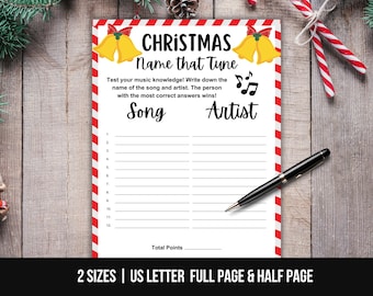 May include: A white Christmas-themed game sheet with red and white striped borders. The sheet features the text "CHRISTMAS Name that Tune" and prompts for song and artist names. A black pen rests on the sheet.
