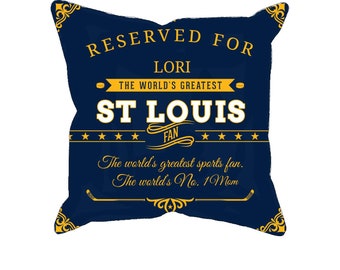 May include: Navy blue decorative pillow with gold and white text. The pillow reads "RESERVED FOR LORI" and "ST LOUIS FAN". Additional text includes "The world's greatest sports fan. The world's No. 1 Mom."