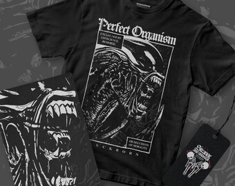 May include: Black t-shirt with a white graphic of an alien creature with the text "Perfect Organism" and "Unclogged by Conscience Remorse or Delusions of Morality" and "Yckborn".