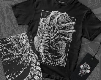 May include: Black t-shirt with a white graphic print of a creature with multiple arms and the text "BLVCKBORN".