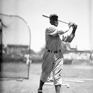 A Print of Jackie Robinson Swinging At Wrigley Field From The Original Negative