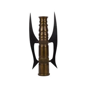 May include: A brass-colored, cylindrical object with a series of ridges and a flared top, flanked by two black, curved, wing-like structures. The object has a metallic sheen and is set against a plain white background.
