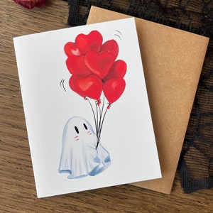 Tarjeta de felicitación con forma de corazón y globo espeluznante. Alternativa caprichosa para aniversarios, celebraciones, arte fantasmal y tarjetas personalizadas