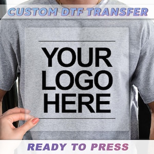 a person holding a transparent sheet with the text "YOUR LOGO HERE" printed on it.