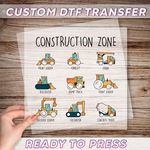 May include: A clear sheet with the text "CUSTOM DTF TRANSFER" and "CONSTRUCTION ZONE" in a playful font. The sheet features illustrations of construction vehicles like a front loader, forklift, crane, bulldozer, dump truck, backhoe loader, excavator, and concrete mixer. The text "READY TO PRESS" is also visible.