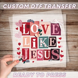 May include: A ready-to-press DTF transfer with the words "LOVE LIKE JESUS" in a collage of colorful letter blocks. The design includes hearts, roses, and the text "CUSTOM DTF TRANSFER" and "READY TO PRESS".