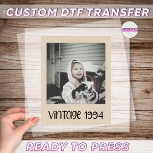 May include: A clear sheet featuring a vintage photograph of a young girl in a snowy scene, with the text "Vintage 1994". The sheet also has the text "CUSTOM DTF TRANSFER" and "READY TO PRESS".