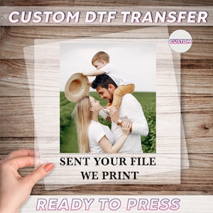 May include: Custom DTF transfer featuring a family portrait. The image shows a man, woman, and child. Text on the transfer reads "SENT YOUR FILE WE PRINT" and "READY TO PRESS". A custom circle logo is in the upper right corner.