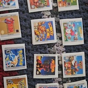 May include: A collection of vintage Game Boy game cartridges, featuring titles like "Donkey Kong Land," "Kirby's Dream Land," and "Pokémon." The cartridges are in their original packaging, with colorful game art.