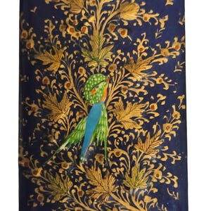 May include: Rectangular, navy blue box with a detailed gold floral design and a colorful bird illustration. The bird has green, blue, and orange accents. The box has a glossy finish.