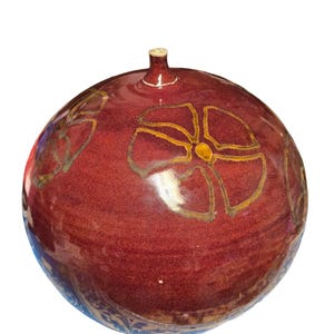 May include: A round, red ceramic vase with a glossy finish. The vase features gold-coloured floral designs and a small spout at the top. The base has a blue and white patterned border. This decorative vase is suitable for home decor.