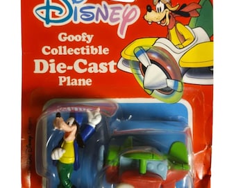 Figura de avión de metal fundido a presión vintage de Disney Goofy fabricada por Arco Toys, número de modelo 6198. Sin abrir.