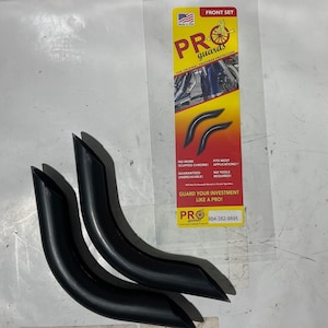 May include: Two black motorcycle crash bar protectors, designed to prevent scuffs and damage. The product packaging is visible in the background, featuring the brand name "PRO guards" and the tagline "The Original Crashbar Protectors".