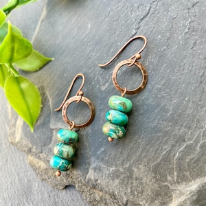 May include: Copper earrings with a hammered circle and three turquoise green beads.