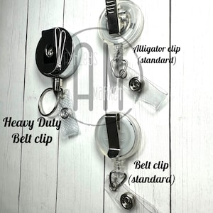 May include: Three retractable badge reels with different clip styles. The first reel has a heavy duty belt clip. The second reel has an alligator clip (standard). The third reel has a belt clip (standard).