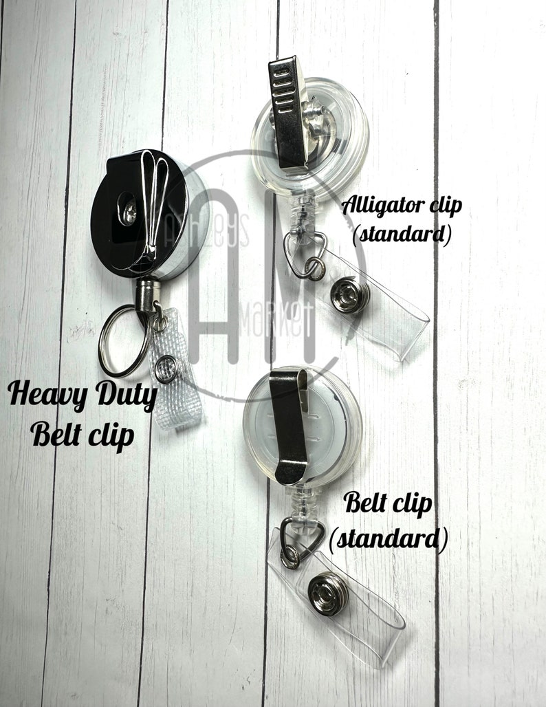 May include: Three retractable badge reels with different clip styles. The first reel has a heavy duty belt clip. The second reel has an alligator clip (standard). The third reel has a belt clip (standard).