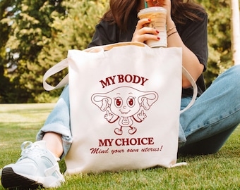 Humorvoller feministischer Jutebeutel, My body my choice, Cartoon Uterus Mascottchen Retro Stil mit feministischer Botschaft, Protest Mode