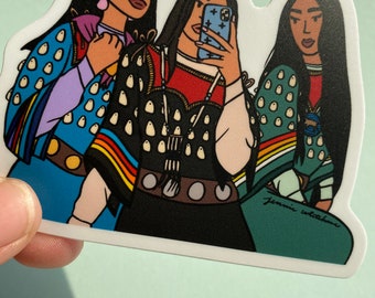 May include: Three women with long black hair wearing colorful traditional clothing and jewelry. The woman in the middle is taking a selfie with a smartphone. The sticker has the artist's signature "Jenni Witchen" in the bottom right corner.