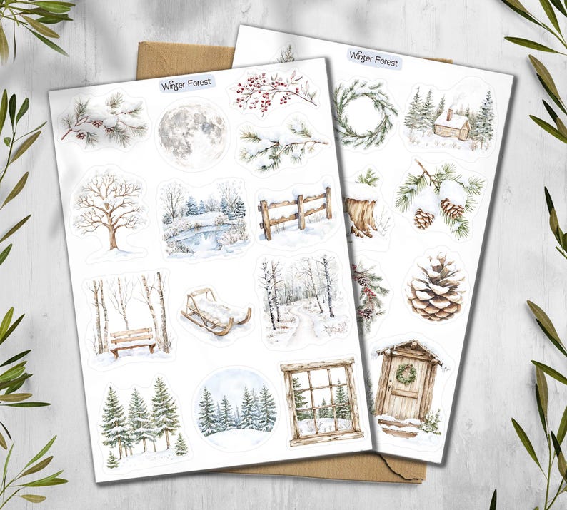 May include: Two sheets of winter-themed stickers with watercolor illustrations. The stickers feature snowy scenes, including a full moon, pine cones, a wooden fence, a sled, and a cabin. The text "Winter Forest" is at the top.