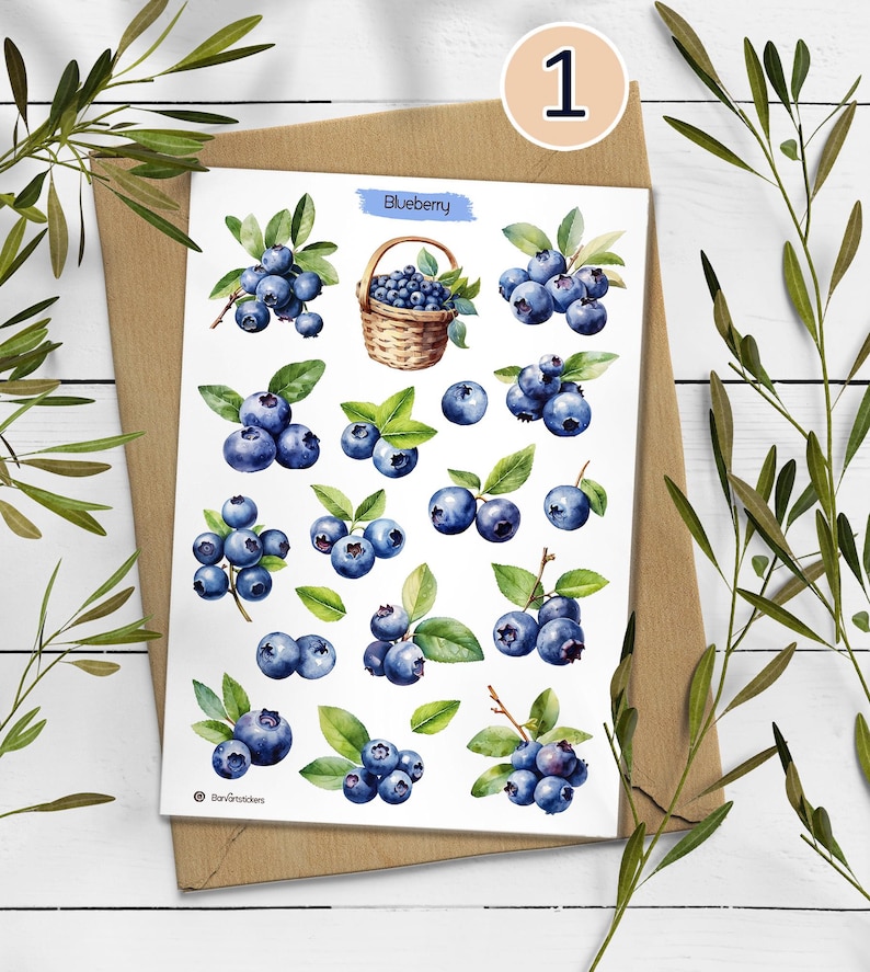 May include: A sticker sheet featuring watercolor illustrations of blueberries, including individual berries, clusters with green leaves, and a woven basket filled with blueberries. The text "Blueberry" is printed in blue at the top center.