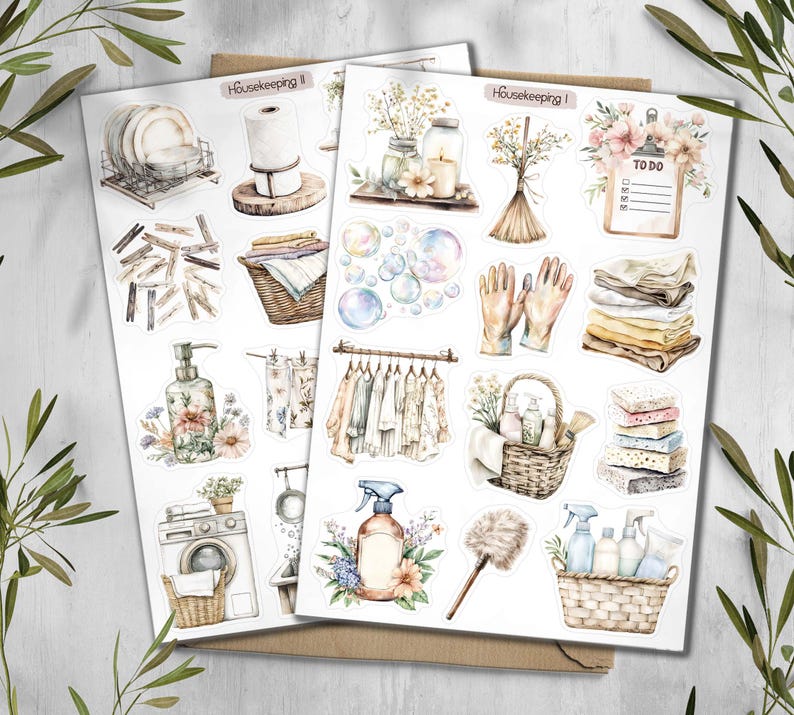 May include: Two sheets of stickers with watercolor illustrations of household items. The stickers include images of dishes, laundry, cleaning supplies, and a to-do list. The sheets are labeled "Housekeeping I" and "Housekeeping II".
