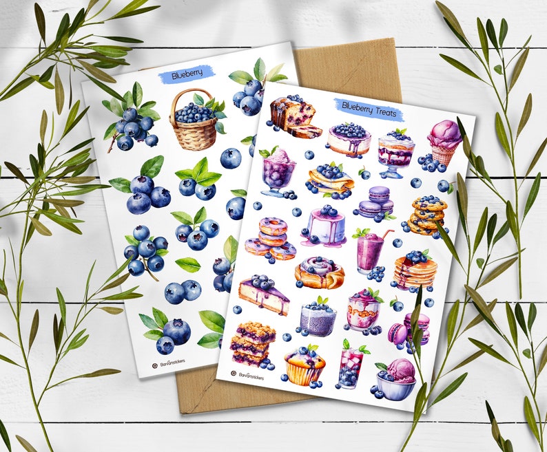 May include: Two white sticker sheets featuring watercolor illustrations. One sheet labeled Blueberry displays various clusters of fresh blueberries and a woven basket. The second sheet labeled Blueberry Treats shows desserts like cakes, pancakes, and ice cream topped with blueberries.