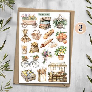 May include: A sticker sheet titled Farmers Market featuring watercolor illustrations of a wooden cart with flowers, stacked crates, a hanging flower basket, wooden spoons, a wicker basket, bread, peaches, potatoes, a rolling pin, a bicycle, a bouquet, a lemon tree, fish in a crate, a paper bag with bread, and a market stall.