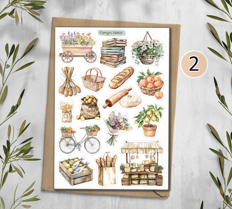May include: A sticker sheet titled Farmers Market featuring watercolor illustrations of a wooden cart with flowers, stacked crates, a hanging flower basket, wooden spoons, a wicker basket, bread, peaches, potatoes, a rolling pin, a bicycle, a bouquet, a lemon tree, fish in a crate, a paper bag with bread, and a market stall.