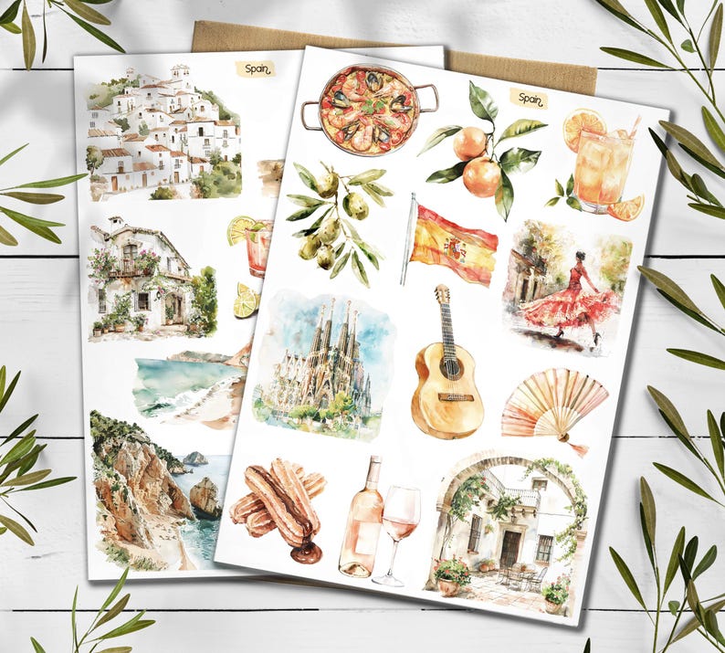 May include: Two sheets of watercolour illustrations showcasing Spanish culture. Images include paella, oranges, a Spanish flag, a flamenco dancer, a guitar, and architectural landmarks. The word "Spain" is written on the top of the sheets.