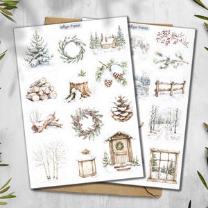 May include: Two sheets of winter forest-themed stickers. The stickers feature watercolor illustrations of snowy trees, wreaths, a cabin, a full moon, a wooden fence, and a lantern. The text "Winter Forest" is printed at the top of the sheets.