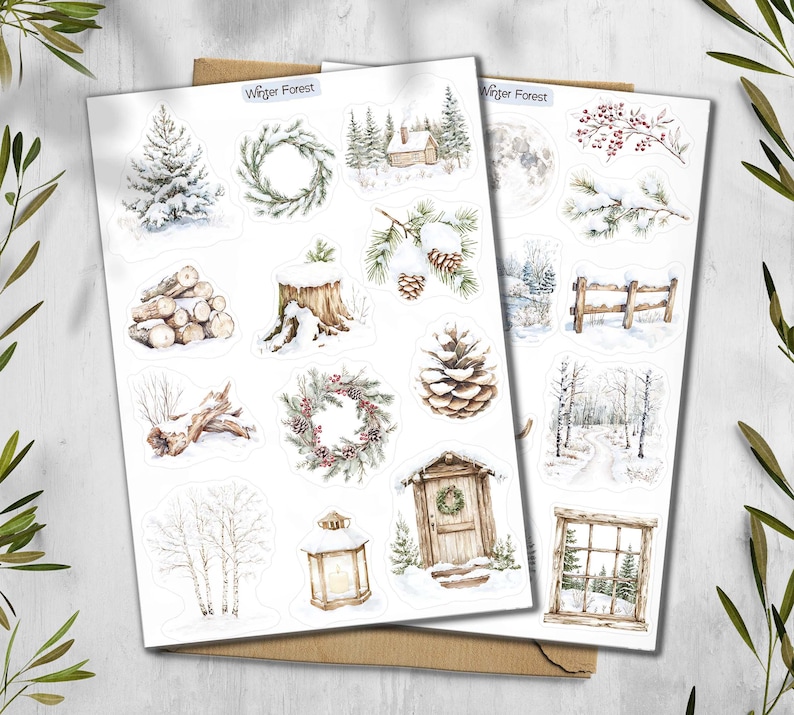 May include: Two sheets of winter forest-themed stickers. The stickers feature watercolor illustrations of snowy trees, wreaths, a cabin, a full moon, a wooden fence, and a lantern. The text "Winter Forest" is printed at the top of the sheets.