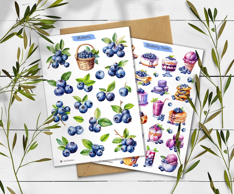 May include: Two white sticker sheets featuring watercolor illustrations of blueberries and blueberry-themed desserts. The first sheet is labeled Blueberry and shows berries and a basket. The second sheet is labeled Blueberry Treats and shows cakes, pancakes, and ice cream.