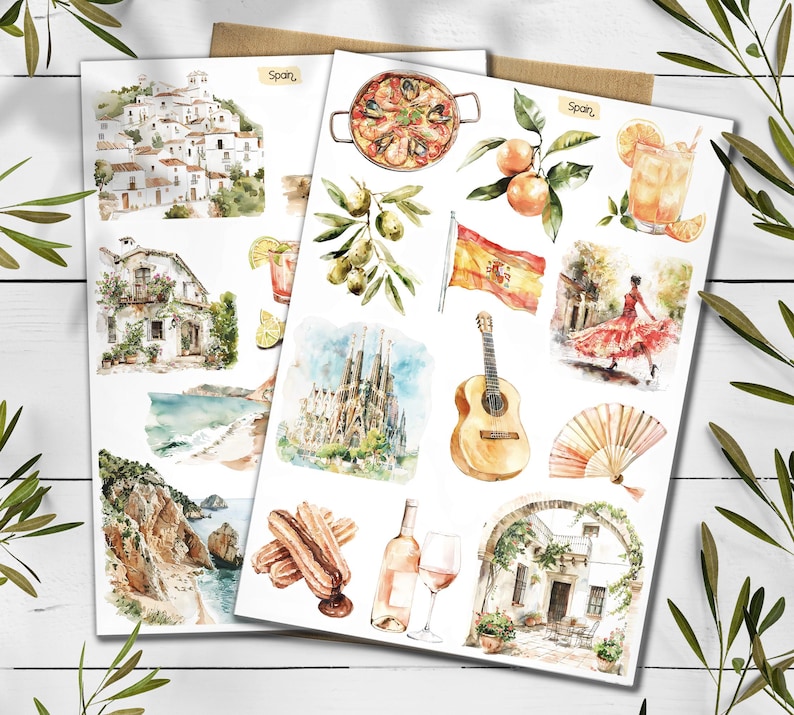 May include: Two sheets of watercolour illustrations depicting Spanish themes. Images include paella, oranges, a Spanish flag, a flamenco dancer, a guitar, and architectural landmarks. The word "Spain" is written on the top of the sheets.