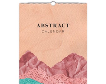 May include: Abstract calendar with a peach background and a design of pink and teal mountains with white polka dots.