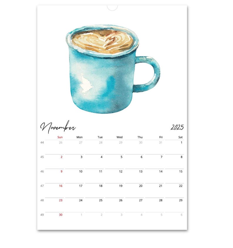 Peut inclure: Une page de calendrier mural pour novembre 2025 pr&eacute;sentant une illustration &agrave; l'aquarelle d'une tasse en c&eacute;ramique bleue remplie de caf&eacute; avec un motif de c&oelig;ur en mousse. La grille du calendrier affiche les jours du mois en noir.