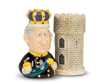May include: Ceramic salt and pepper shaker set featuring a cartoon king wearing a yellow and blue crown and a stone tower.