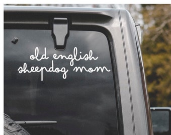 May include: A black car with a white vinyl sticker on the back window that says "old english sheepdog mom".
