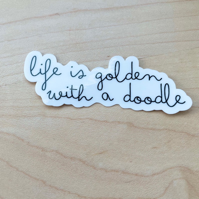 May include: White sticker with black cursive text that reads "life is golden with a doodle".